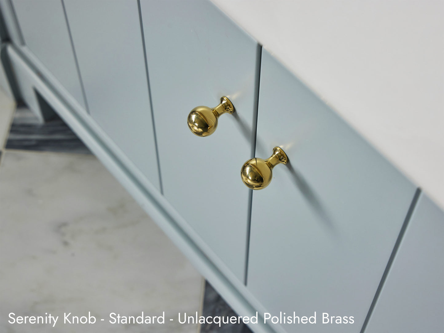 Solid brass Serenity Knob in unlacquered polished brass on kitchen cabinets.
