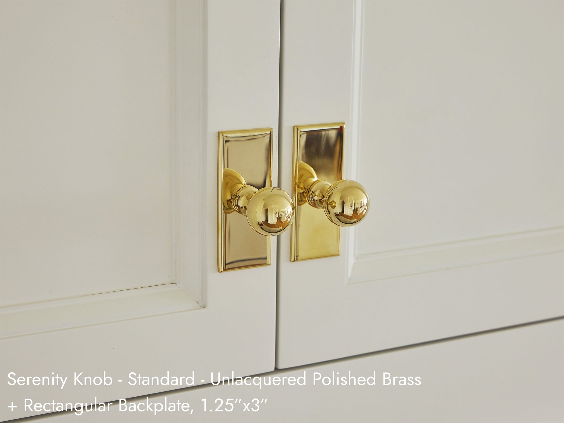 Solid brass Serenity Knob in unlacquered polished brass on kitchen cabinets.