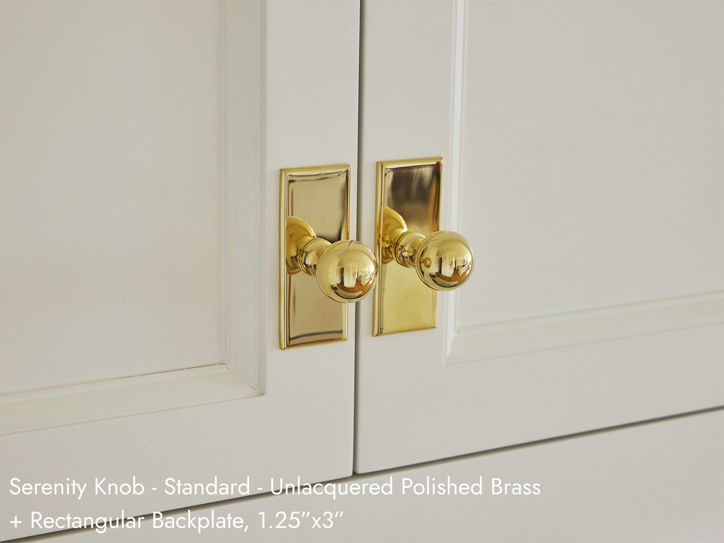 Solid brass Serenity Knob in unlacquered polished brass on kitchen cabinets.