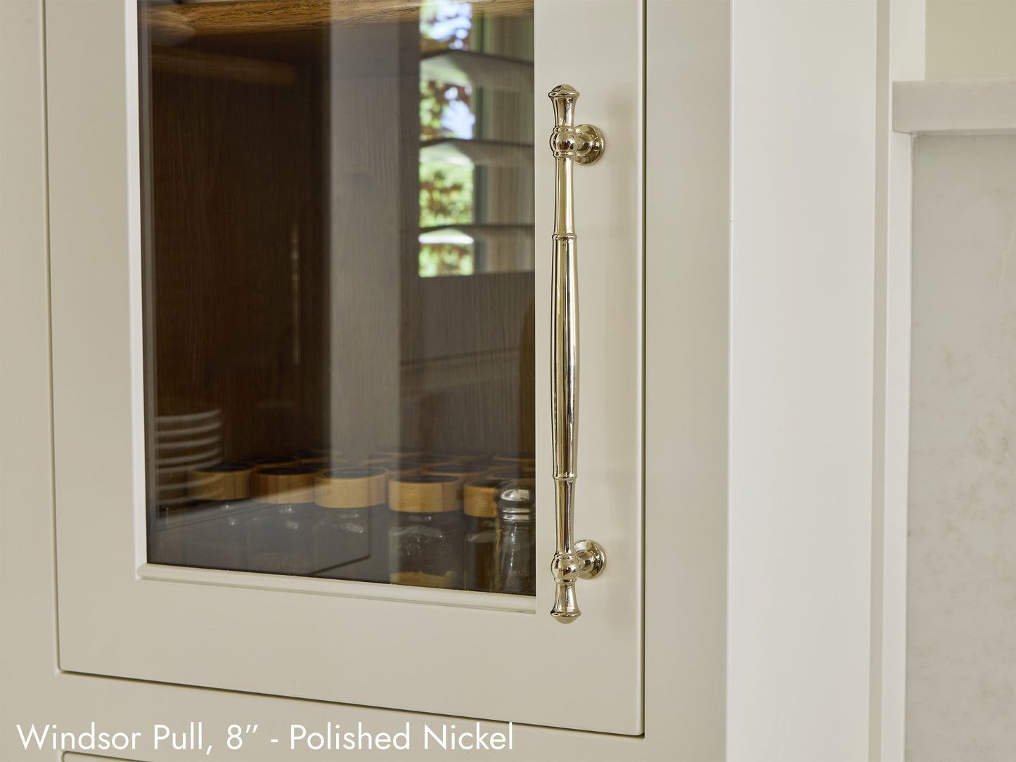 Solid brass Windsor Pull, in polished nickel finish, on kitchen cabinets.