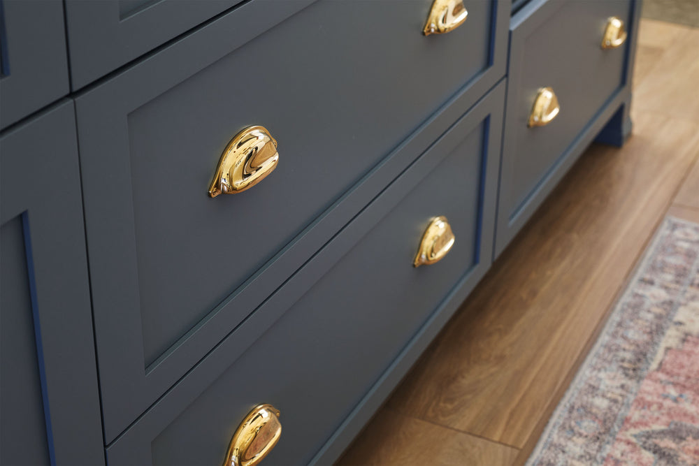 Traditional kitchen with unlacquered brass hardware on its cabinetry.