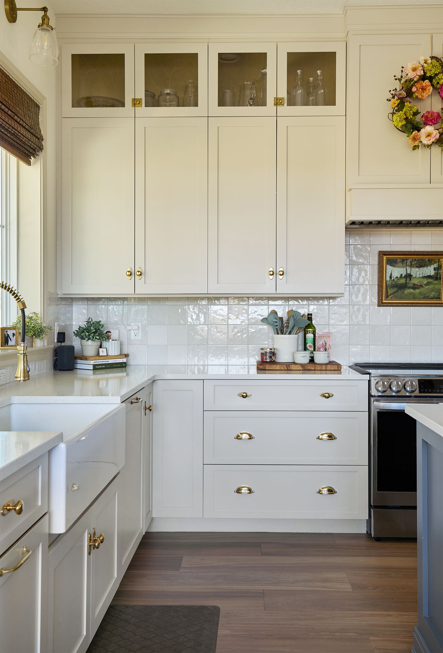 Traditional kitchen with unlacquered brass hardware on its cabinetry.