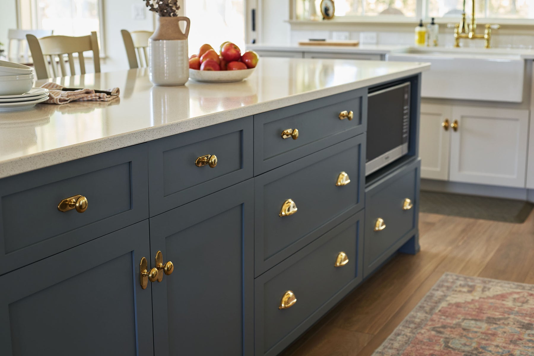 Traditional kitchen with unlacquered brass hardware on its cabinetry.