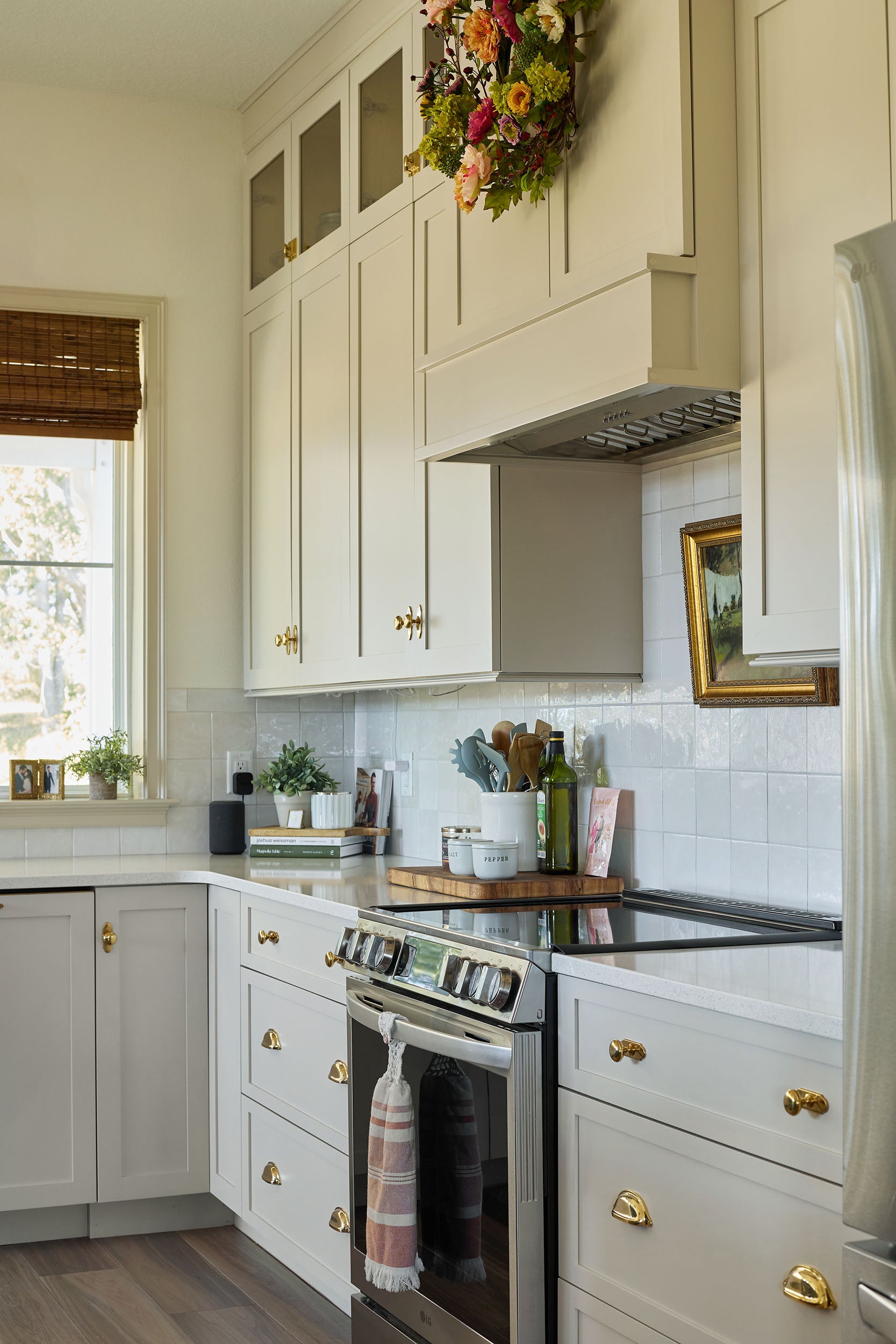 Traditional kitchen with unlacquered brass hardware on its cabinetry.