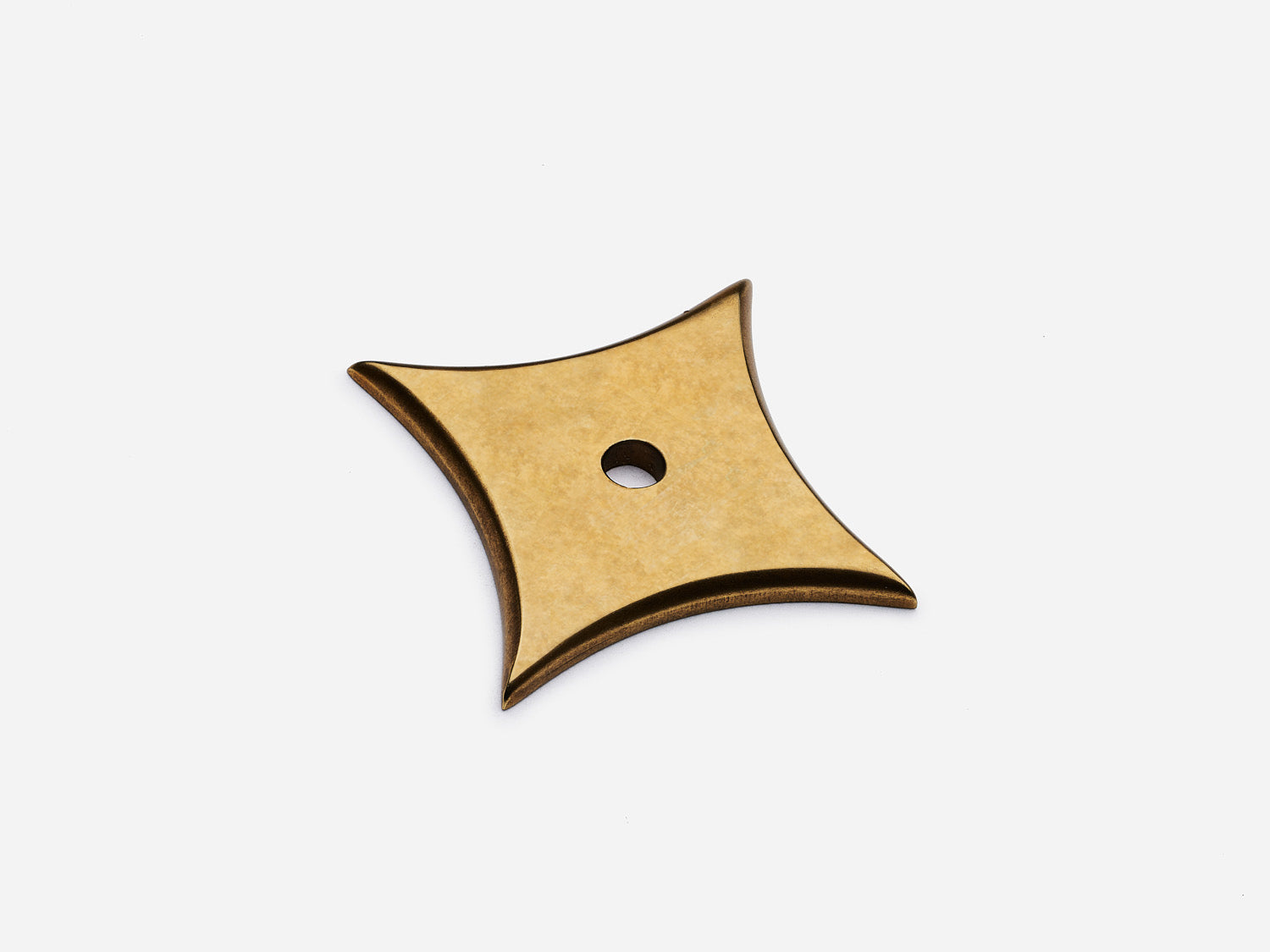 Solid brass 4-Point Star backplate, in an aged brass finish for knobs on cabinets.