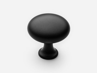 Solid brass Belle Knob, large size, in a matte black finish for cabinets.