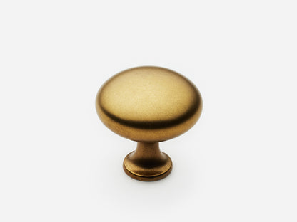 Solid brass Belle Knob, standard size, in an aged brass finish for cabinets.