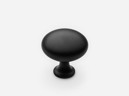 Solid brass Belle Knob, standard size, in a matte black finish for cabinets.