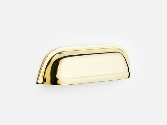 Solid brass Cygnet bin pull, 4 inches, in an unlacquered polished brass finish for cabinets.