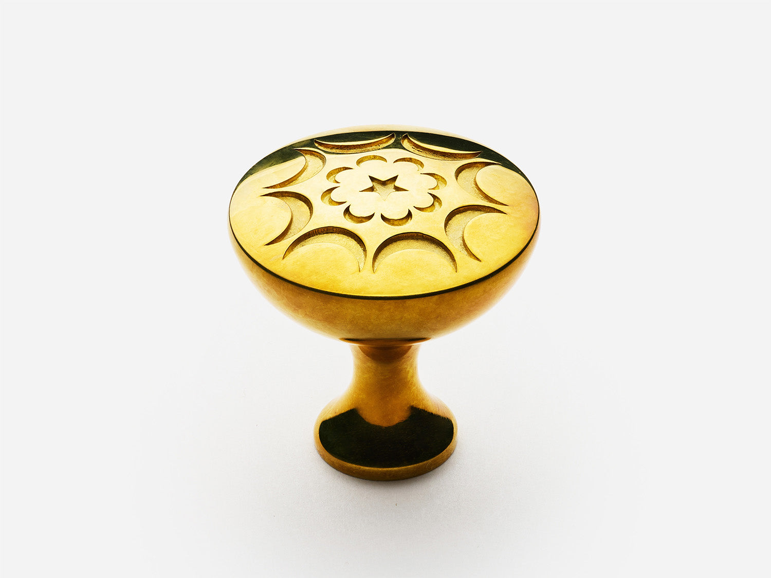 Solid brass Crescent Knob, standard size, in an unlacquered polished brass finish for cabinets.