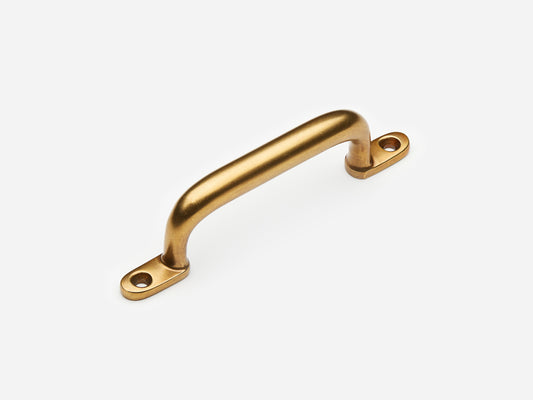 Solid brass Butler drawer pull, 4 inches, in an aged brass finish for cabinets.