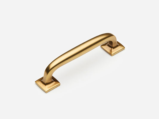 Solid brass Dapper drawer pull, 4 inches, in an aged brass finish for cabinets.