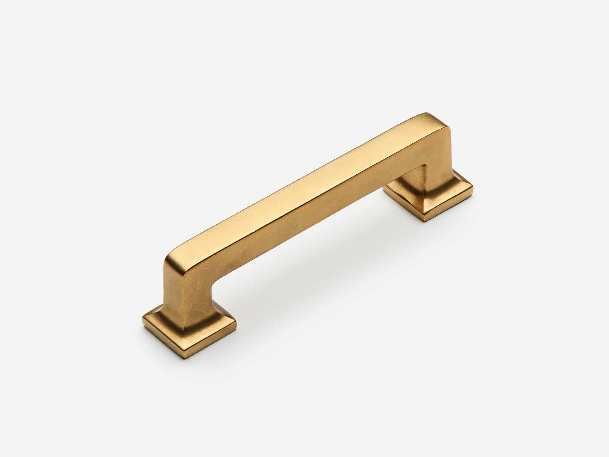 Solid brass Promontory drawer pull, 4 inches, in an aged brass finish for cabinets.