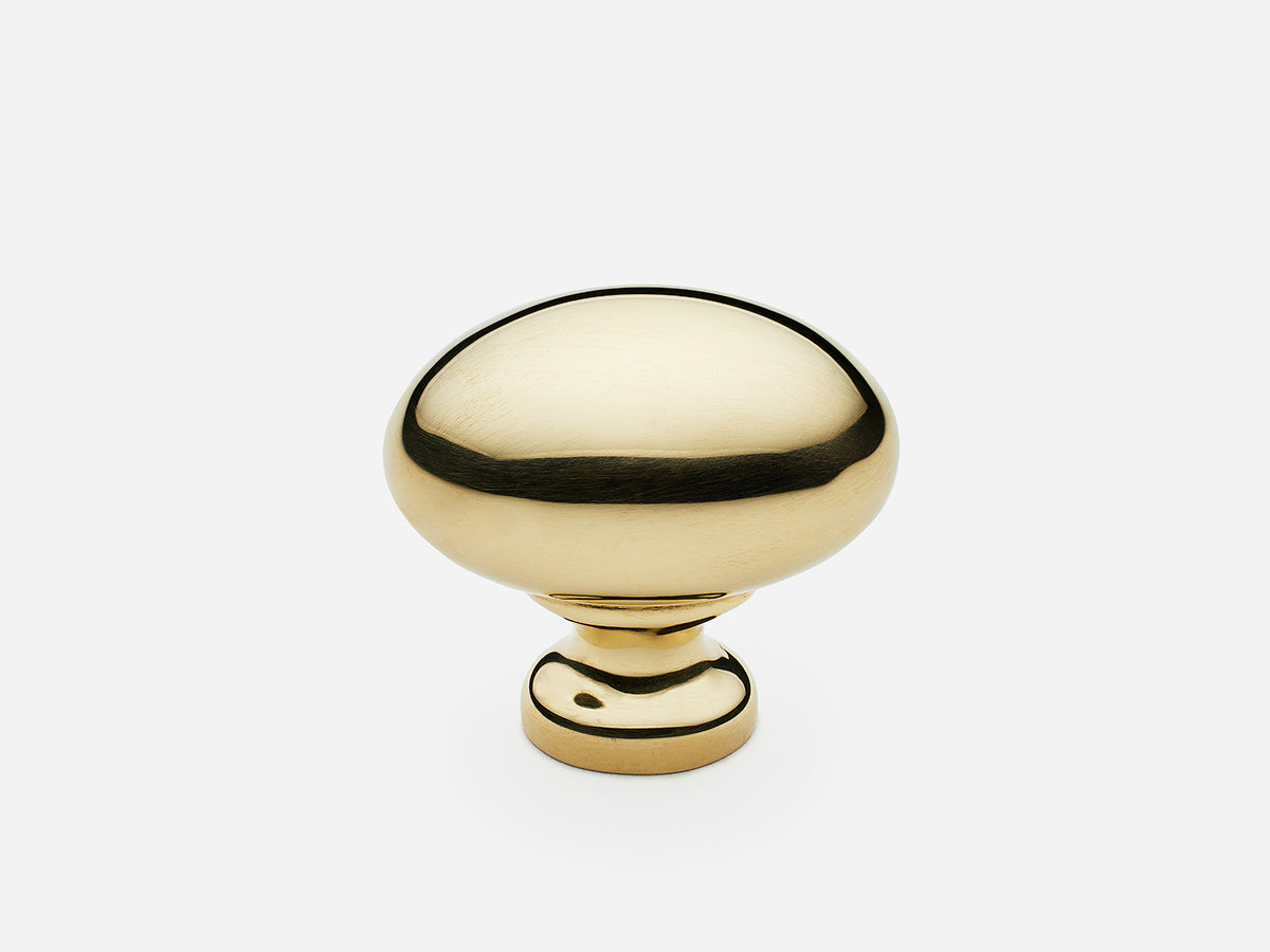 Solid brass Oval Knob, standard size, in an unlacquered polished brass finish for cabinets.