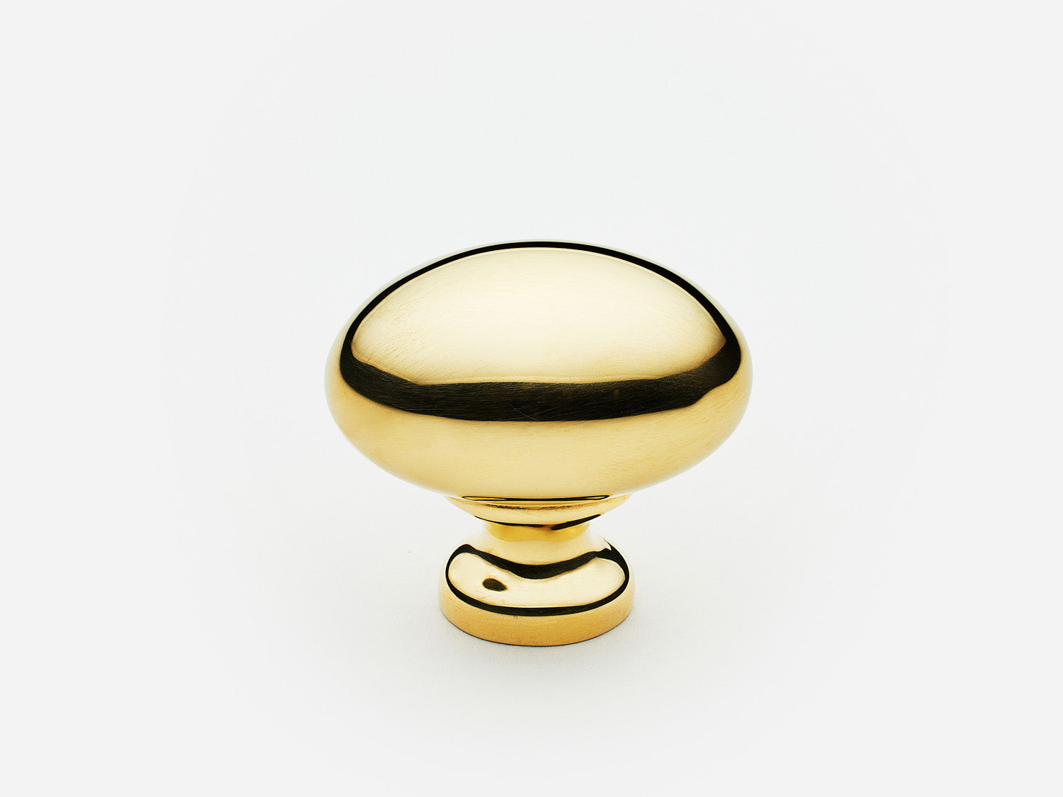 Solid brass Oval Knob, standard size, in an unlacquered polished brass finish for cabinets.