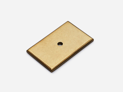 Solid brass rectangular backplate, 1.25x2 inches, aged brass finish for knobs and pulls on cabinets.