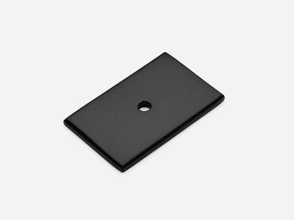 Solid brass rectangular backplate, 1.25x2 inches, matte black finish for knobs and pulls on cabinets.