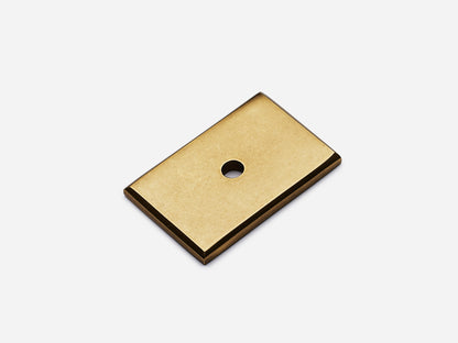 Solid brass rectangular backplate, 1x1.5 inches, aged brass finish for knobs and pulls on cabinets.