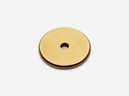 Solid brass Round backplate, 1.25 inches, in an aged brass finish for knobs on cabinets.