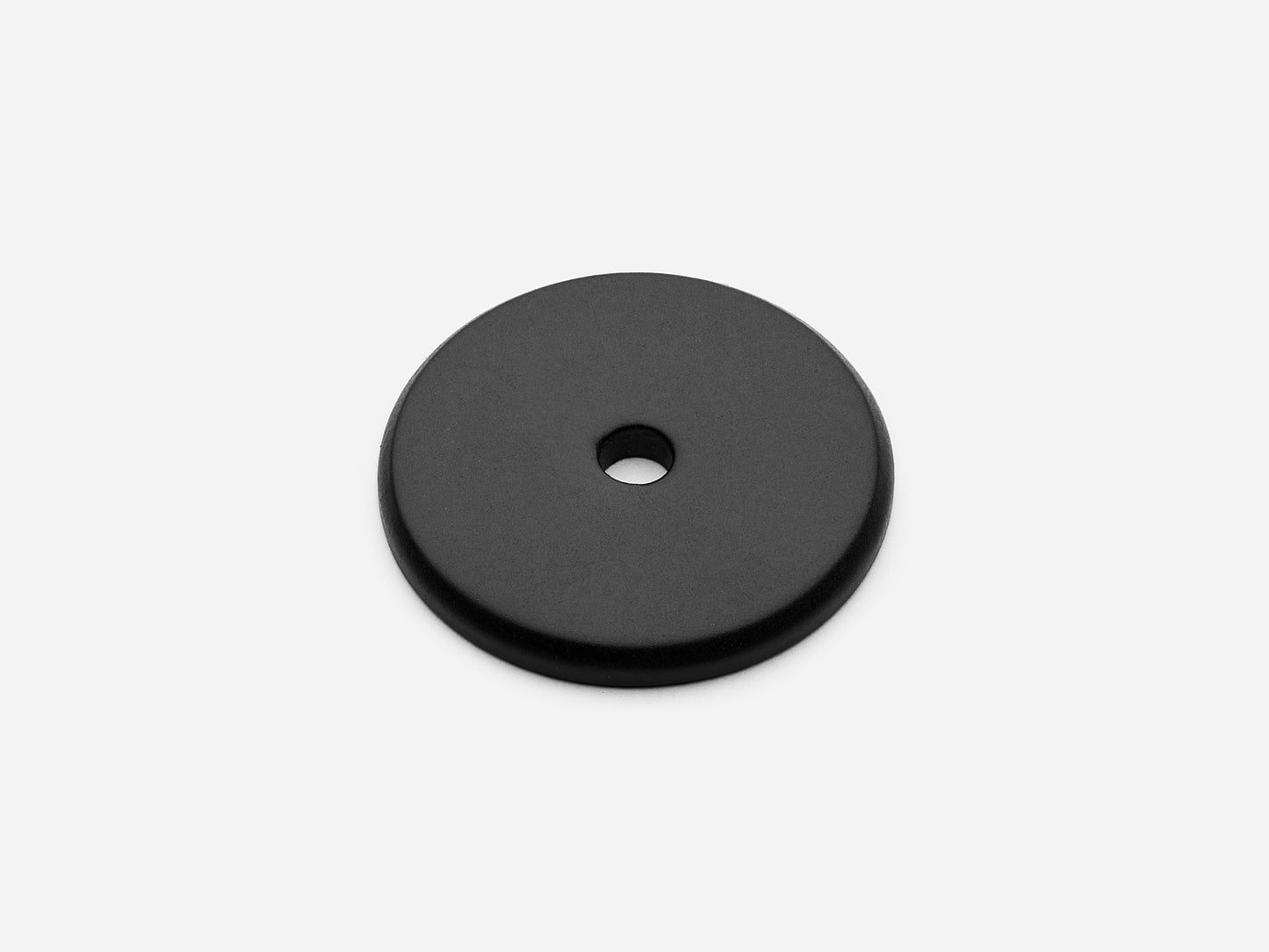 Solid brass Round backplate, 1.25 inches, in a matte black finish for knobs on cabinets.