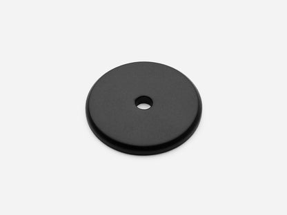 Solid brass Round backplate, 1.25 inches, in a matte black finish for knobs on cabinets.