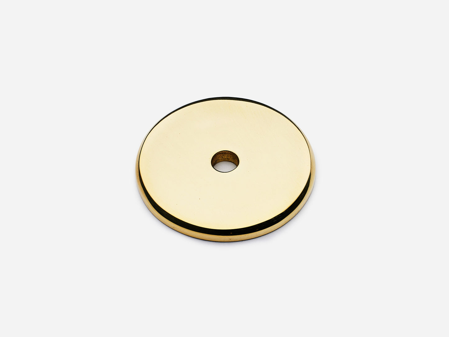 Solid brass Round backplate, 1.25 inches, in an unlacquered polished brass finish for knobs on cabinets.