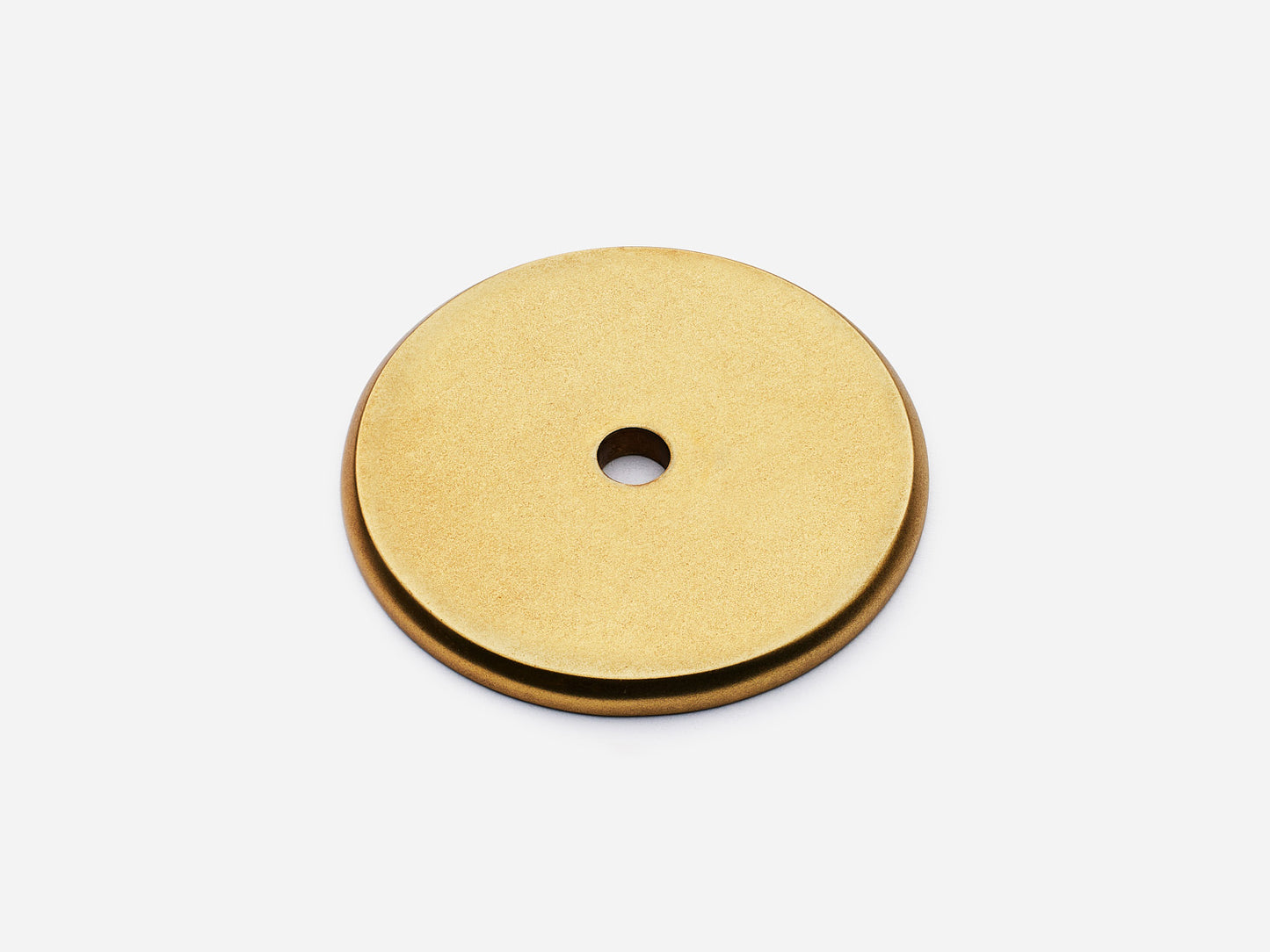 Solid brass Round backplate, 1.5 inches, in an aged brass finish for knobs on cabinets.