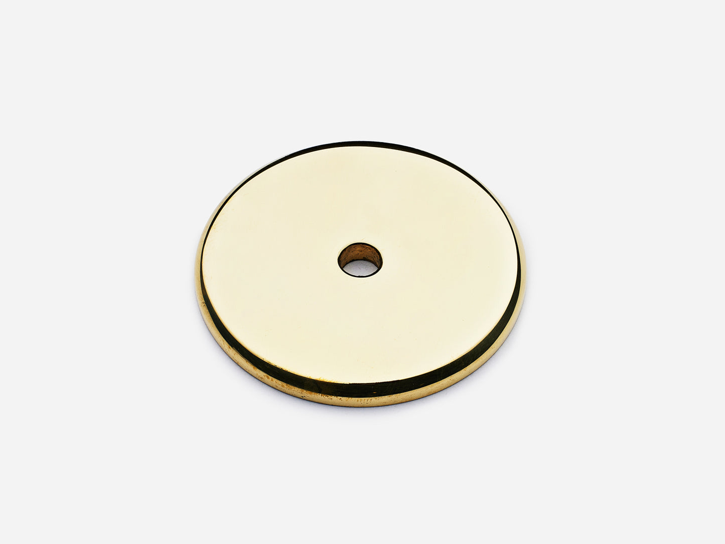 Solid brass Round backplate, 1.5 inches, in an unlacquered polished brass finish for knobs on cabinets.