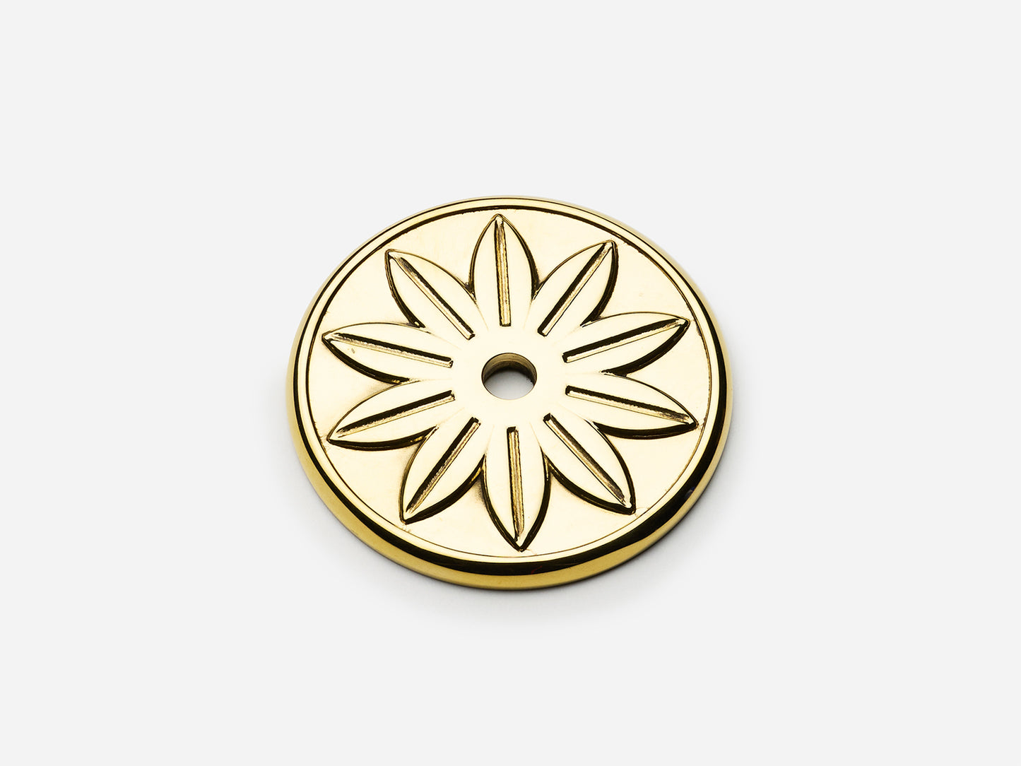 Solid brass Starflower backplate, 1.75 inches, in an unlacquered polished brass finish for knobs on cabinets.