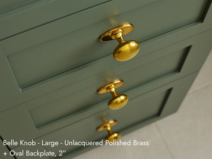 Solid brass Belle Knob, in unlacquered polished brass finish, on kitchen cabinets with Oval Backplate.