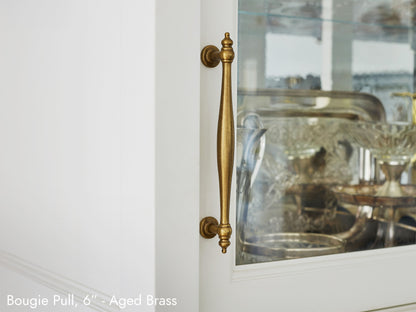 Solid brass Bougie Pull, in aged brass finish, on kitchen cabinets.