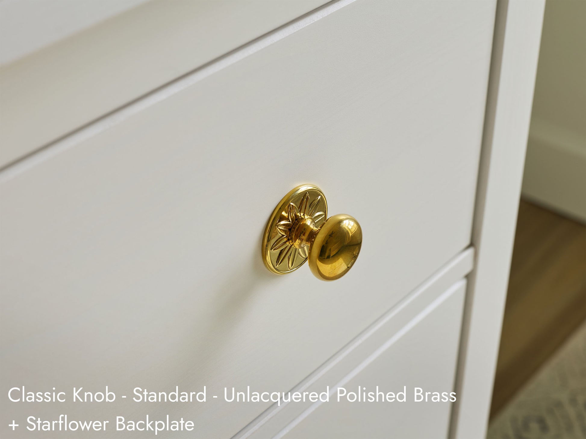 Solid brass Classic Knob, in unlacquered polished brass finish, on cabinets.