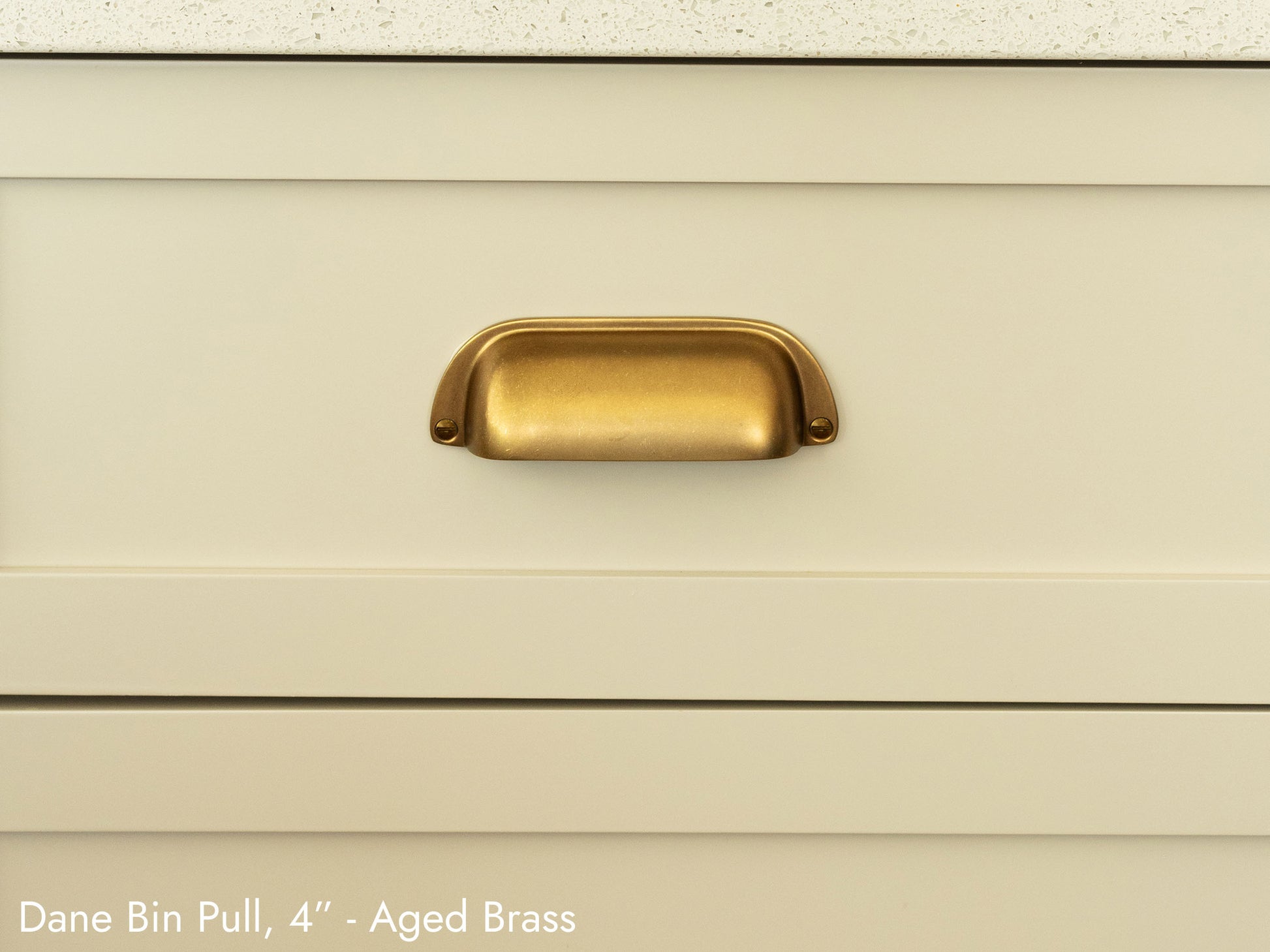 Solid brass Dane Bin Pull, in aged brass finish, on kitchen cabinets.