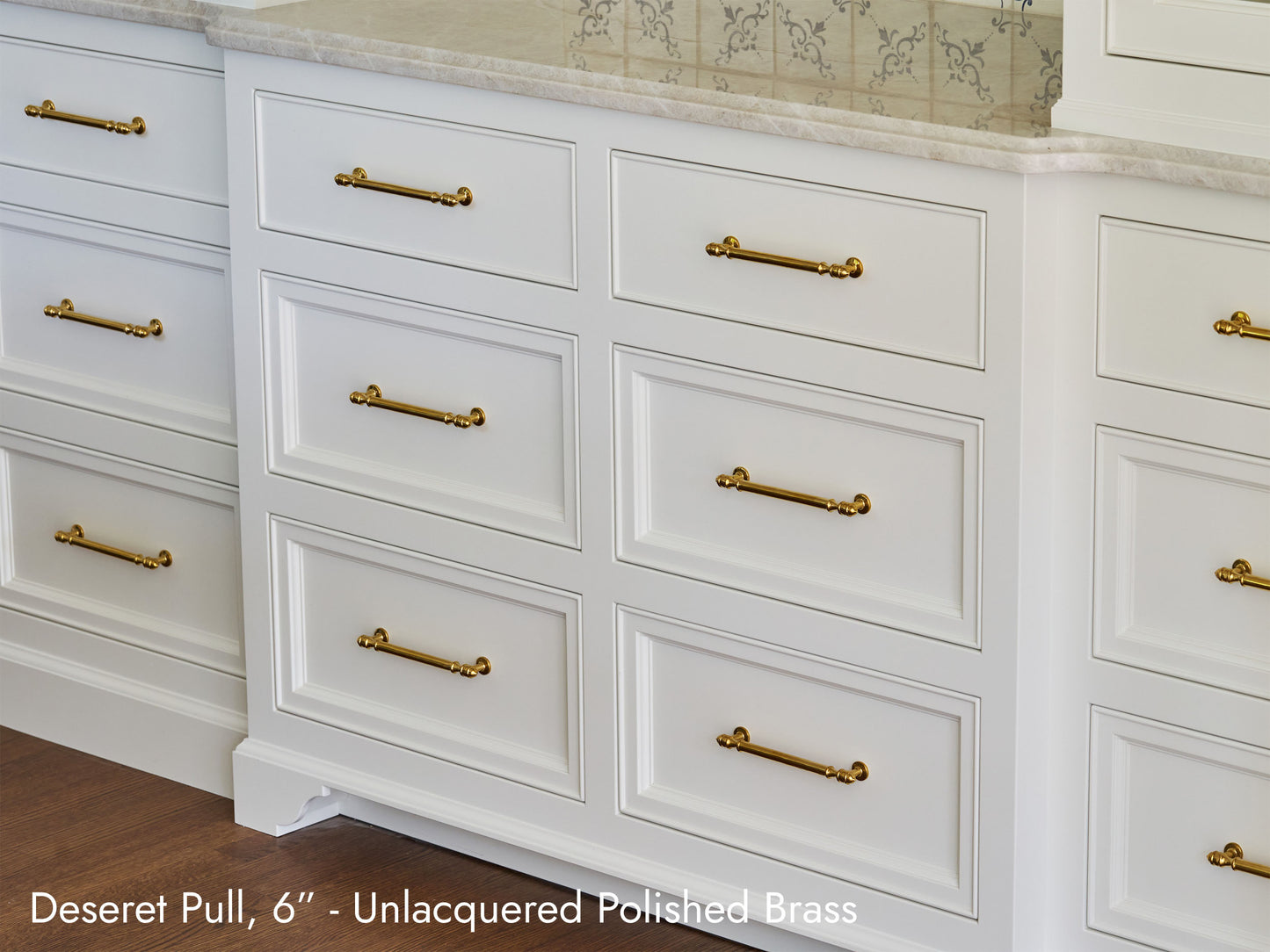 Solid brass Deseret Pull, in unlacquered polished brass, on kitchen cabinets.