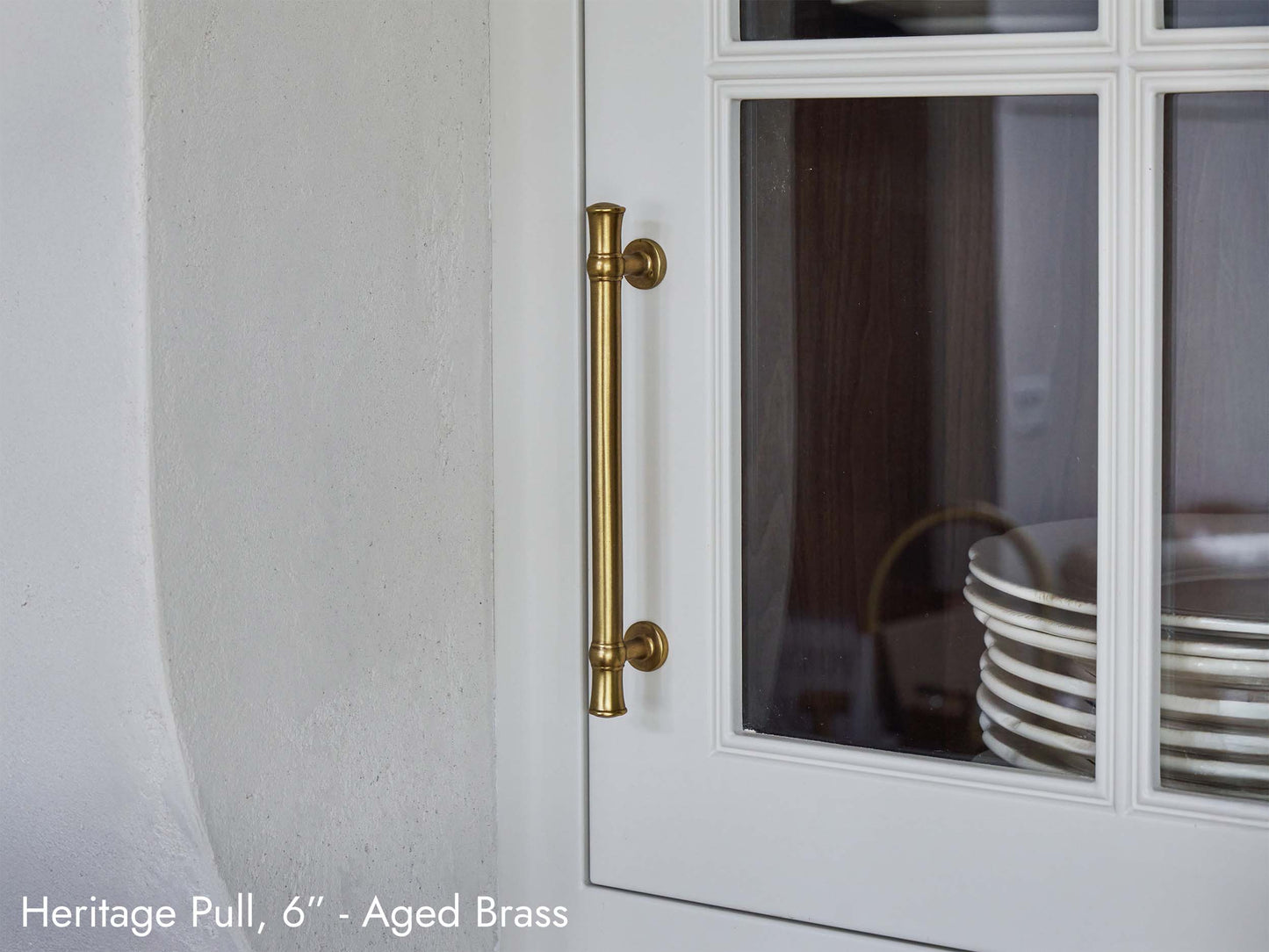 Solid brass Heritage Pull, in aged brass finish, on kitchen cabinets.