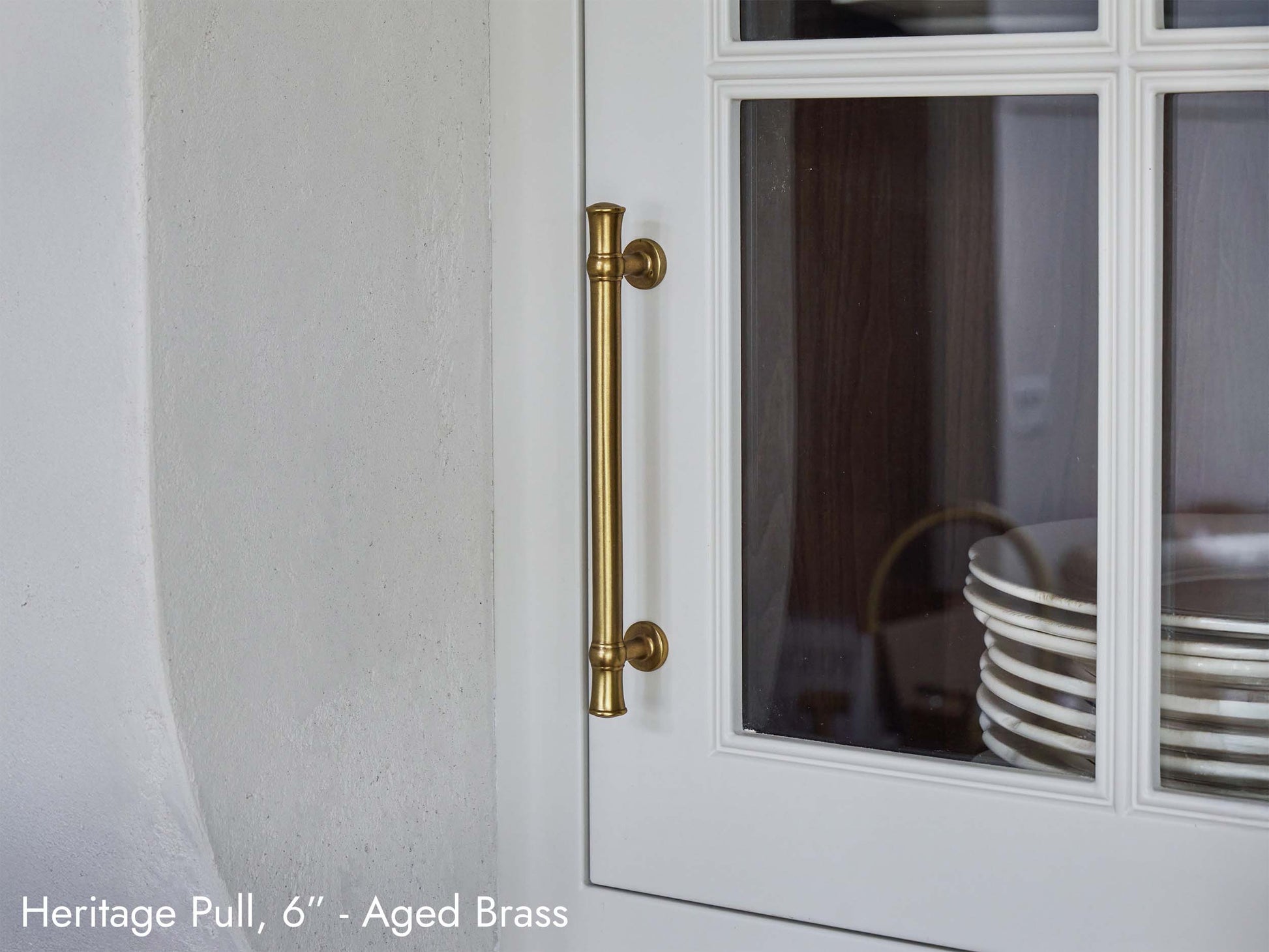 Solid brass Heritage Pull, in aged brass finish, on kitchen cabinets.