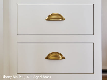 Solid brass Liberty Bin Pull, in aged brass, on kitchen cabinets.