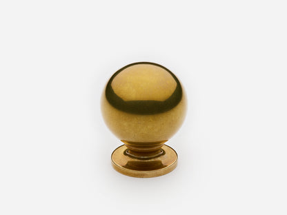 Solid brass Luxe Ball Knob, standard size, in an unlacquered aged brass finish for cabinets.