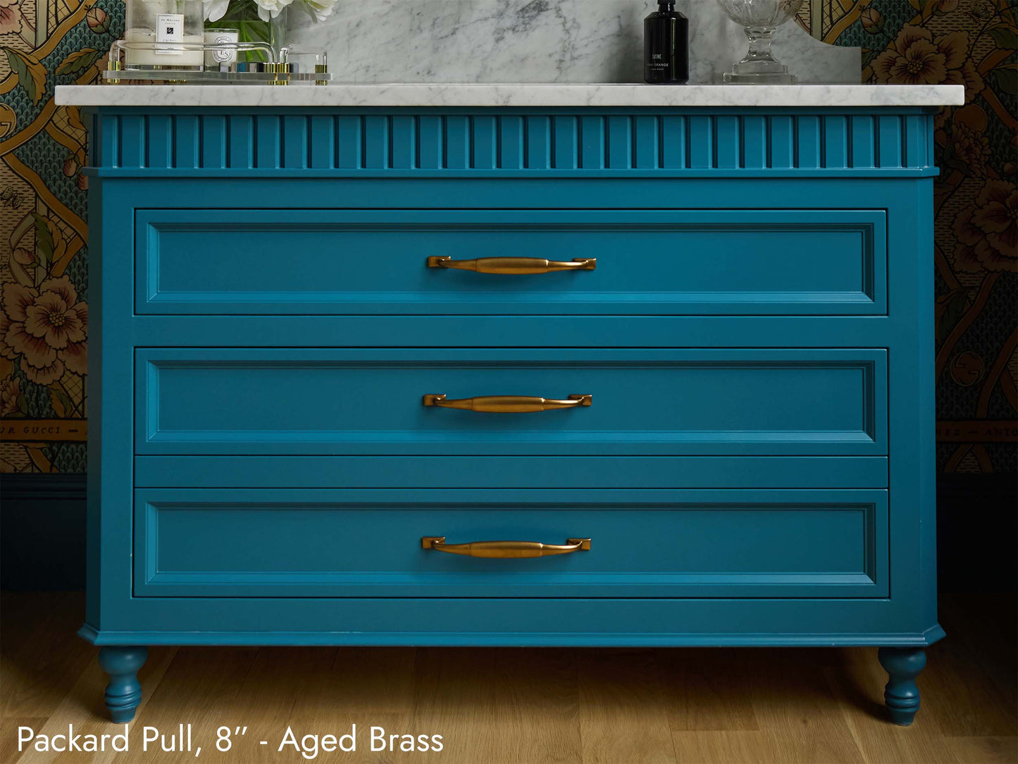 Solid brass Packard Pulls, in aged brass finish, on a bathroom vanity.