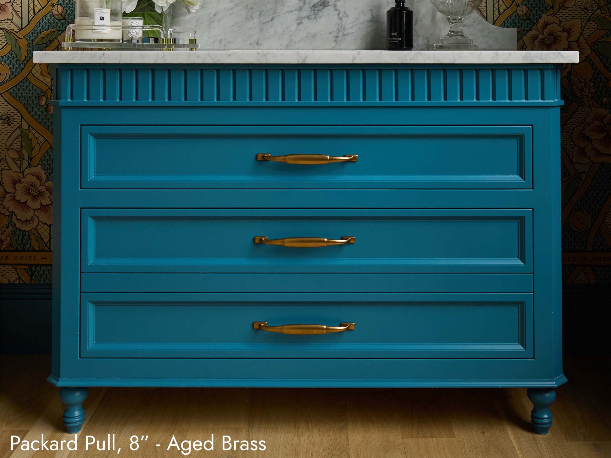 Solid brass Packard Pulls, in aged brass finish, on a bathroom vanity.