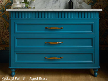 Solid brass Packard Pulls, in aged brass finish, on a bathroom vanity.